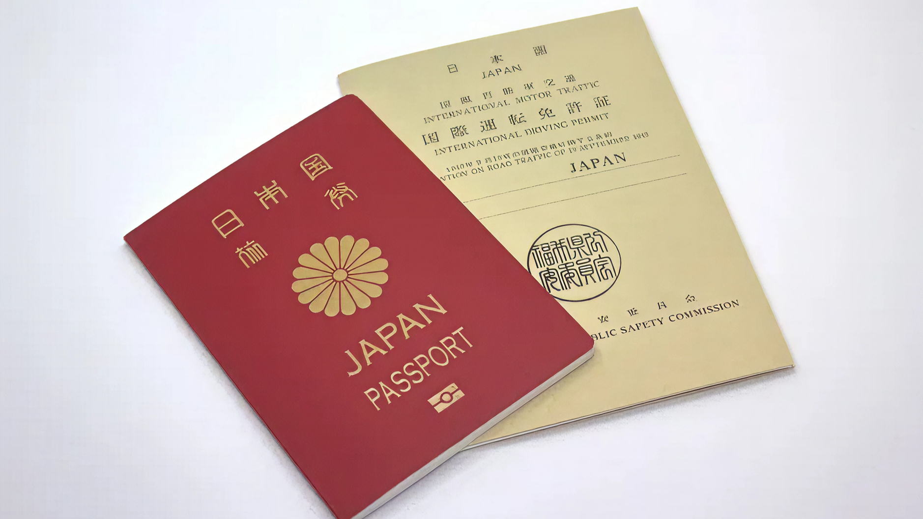 Japanese passport next to an International Driving Permit booklet